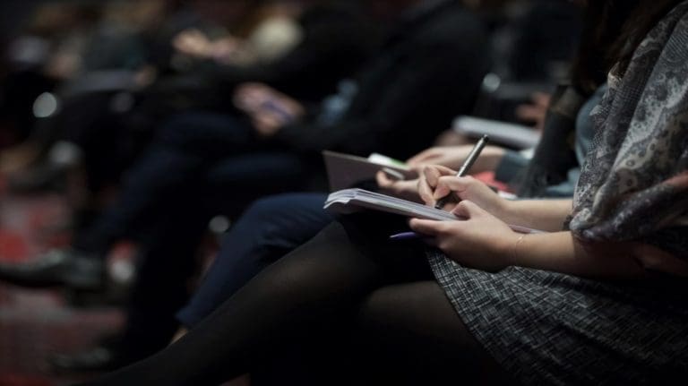 Female writing notes on a note pad