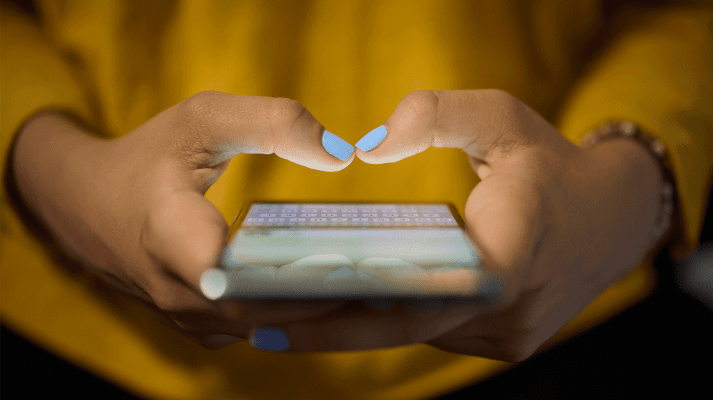girl typing on phone