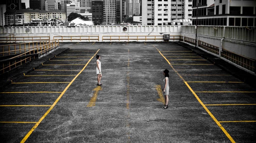 two people standing on rooftop carpark