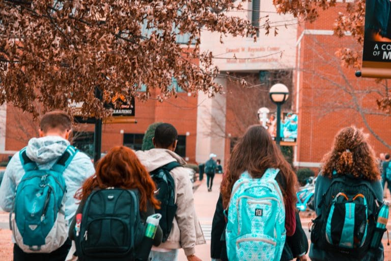 Group of college students wearing backpacks