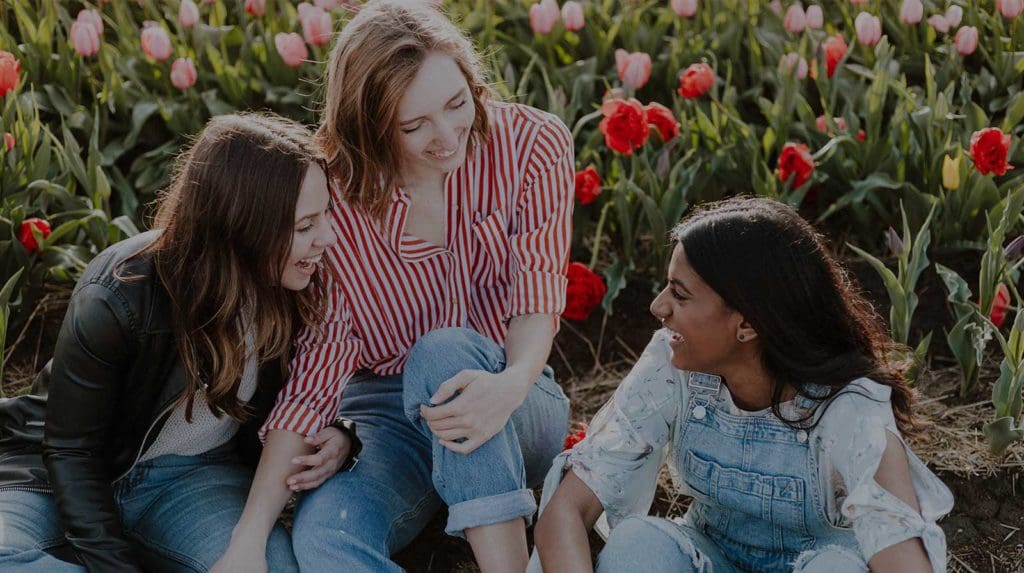 Group of females sat smiling and chatting